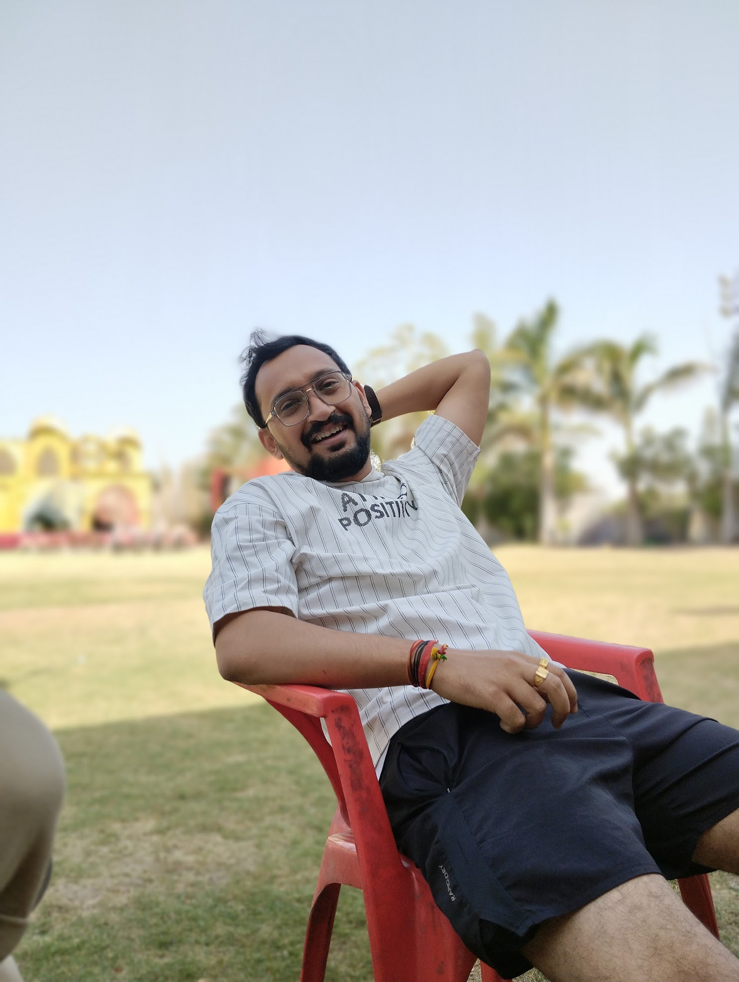 Tanmay grinning, leaning back in a chair